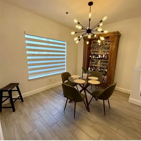 a dining room with furniture and wooden floor