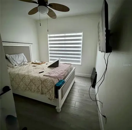 a bedroom with a bed and a chandelier