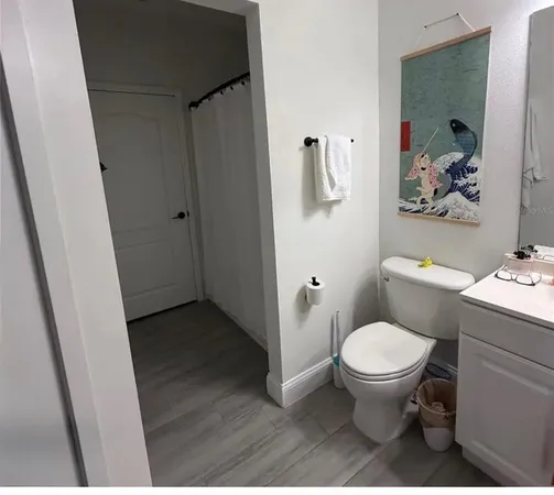 a bathroom with a toilet and a shower curtain