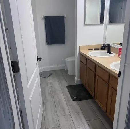 a bathroom with a sink a mirror and a toilet