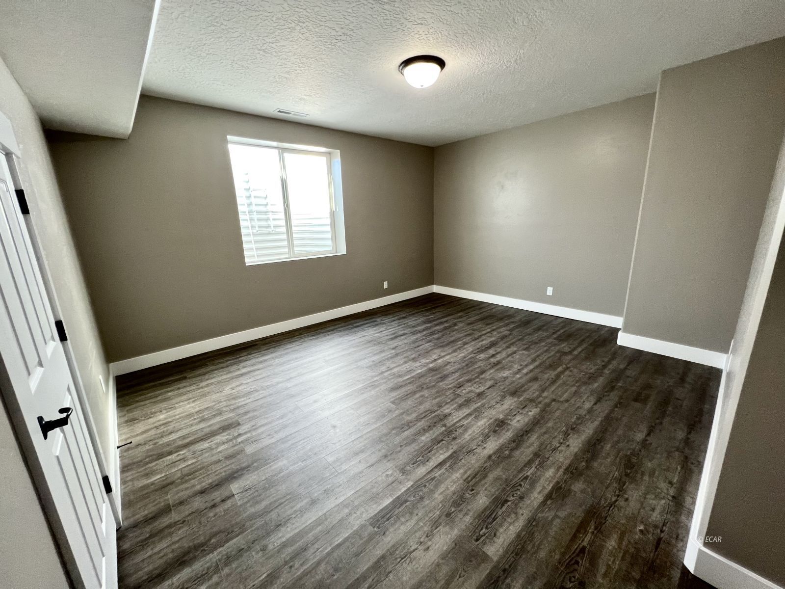 298 Ridgeway Drive Spring Creek, NV 89815 - Photo 35 of 45 an empty room with wooden floor and windows