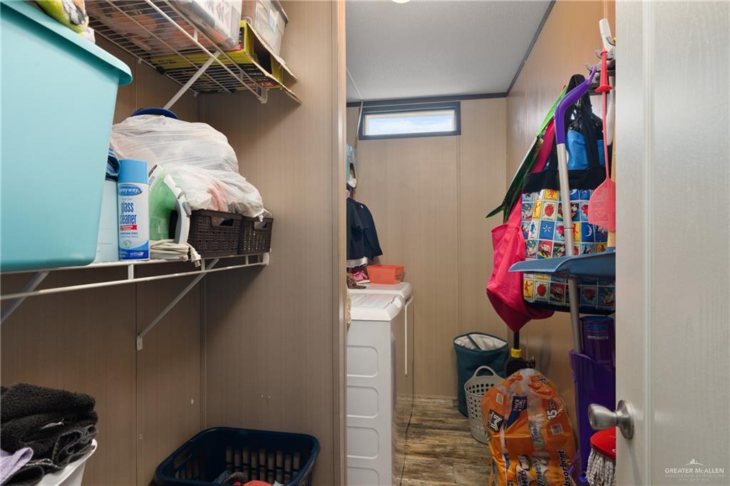 3118 Primrose Drive Weslaco, TX 78596 - Photo 8 of 12 Spacious closet with wood finished floors and washing machine and clothes dryer