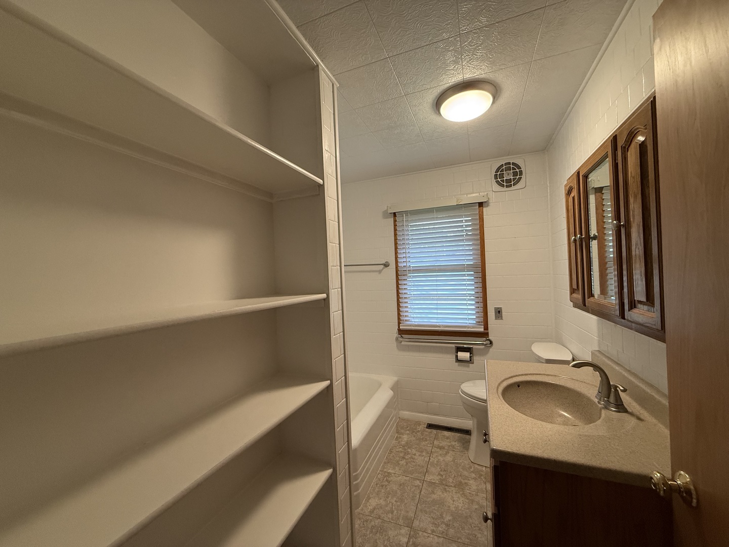 1048 Warren Street Henry, IL 61537 - Photo 15 of 26 a bathroom with a sink and a mirror