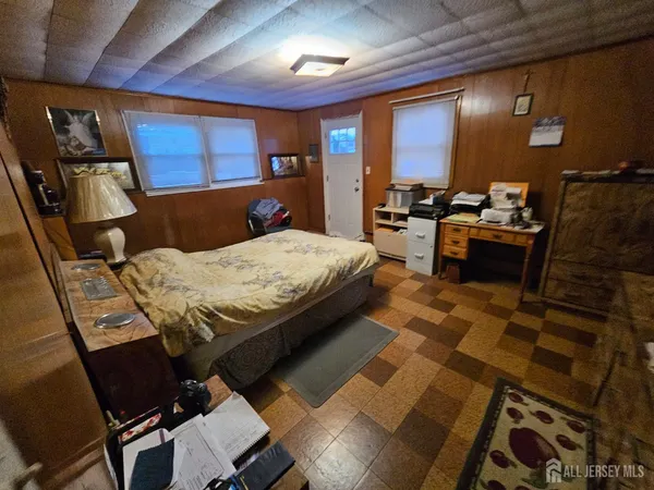 a bedroom with a bed and wooden furniture