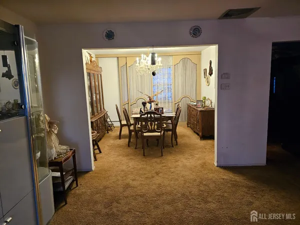 a dining room with furniture and a chandelier