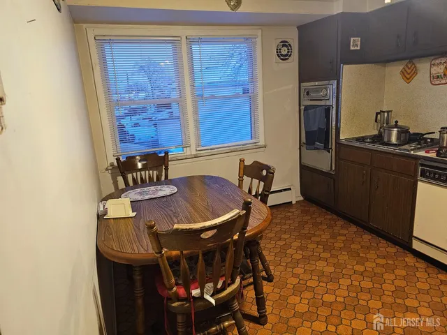 a view of a dining room with furniture and a window