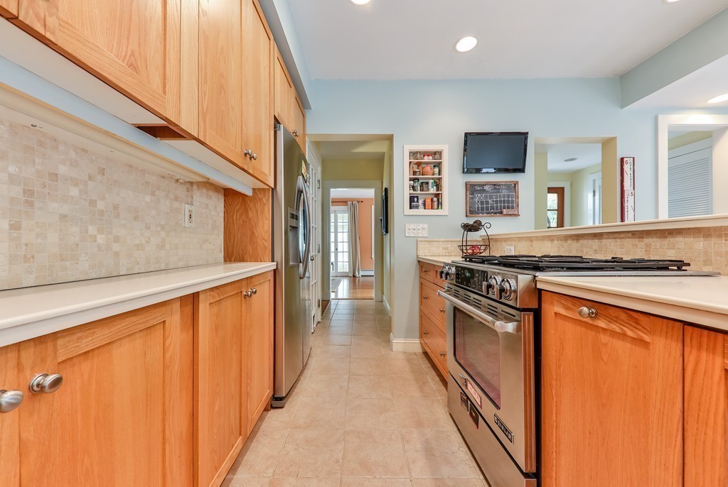 325 Reedsdale Road Milton, MA 02186 - Photo 11 of 23 a kitchen with stainless steel appliances granite countertop a stove a sink and a refrigerator