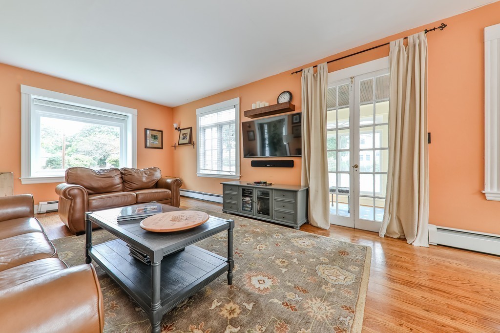 325 Reedsdale Road Milton, MA 02186 - Photo 5 of 23 a living room with furniture a flat screen tv and a large window