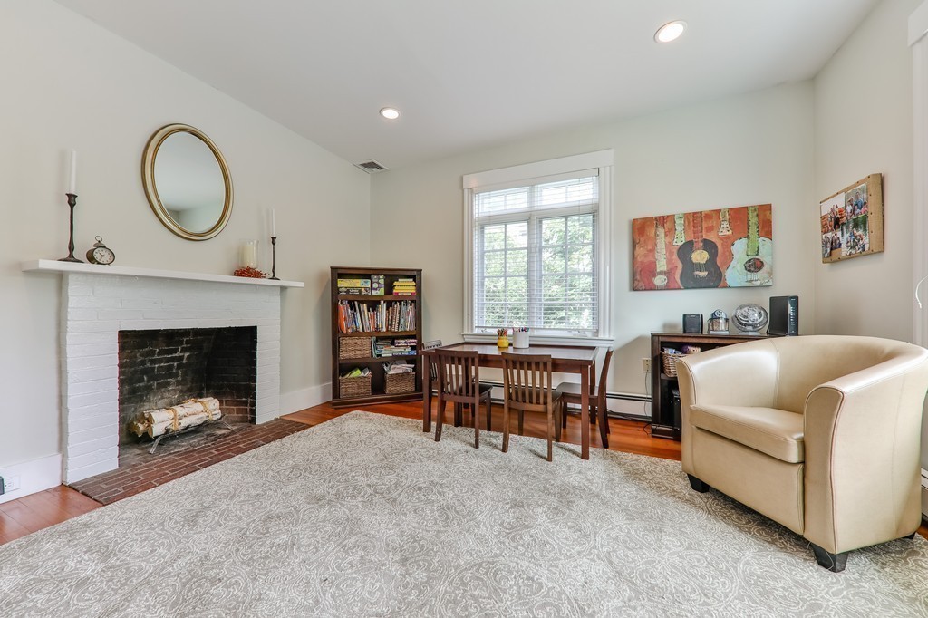 325 Reedsdale Road Milton, MA 02186 - Photo 8 of 23 a living room with furniture a window and a fireplace