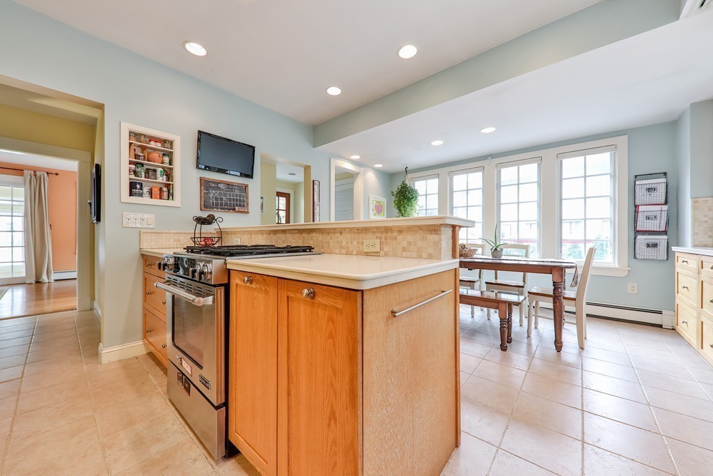 325 Reedsdale Road Milton, MA 02186 - Photo 10 of 23 a kitchen with stainless steel appliances granite countertop a stove and a refrigerator