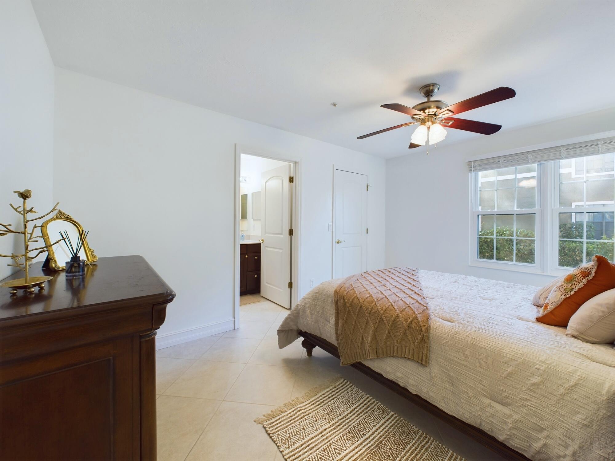 7667 North Wickham Road, Unit 1308 Melbourne, FL 32940 - Photo 12 of 56 a bedroom with a bed and a table