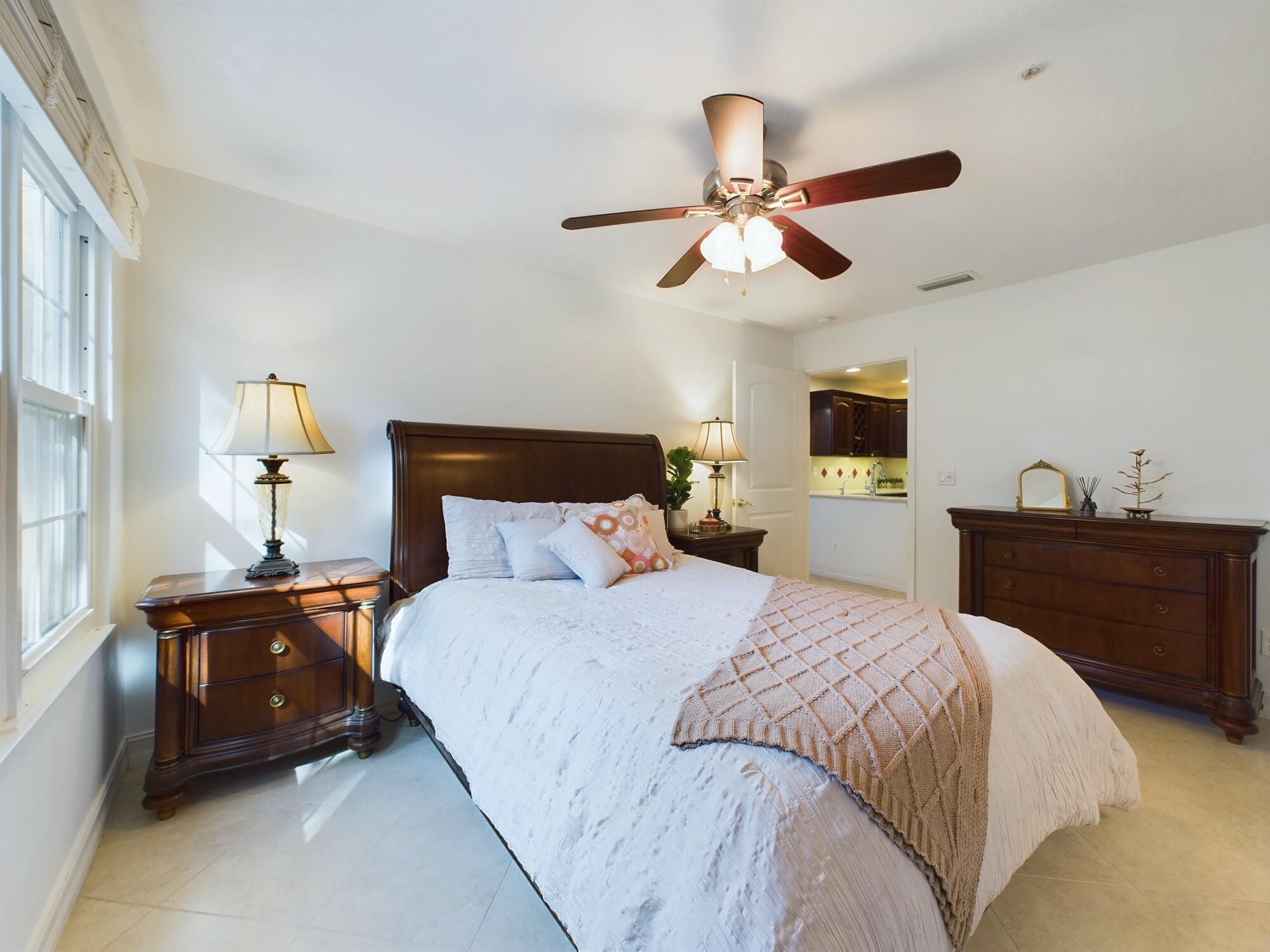 7667 North Wickham Road, Unit 1308 Melbourne, FL 32940 - Photo 14 of 56 a bedroom with a bed and wooden floor