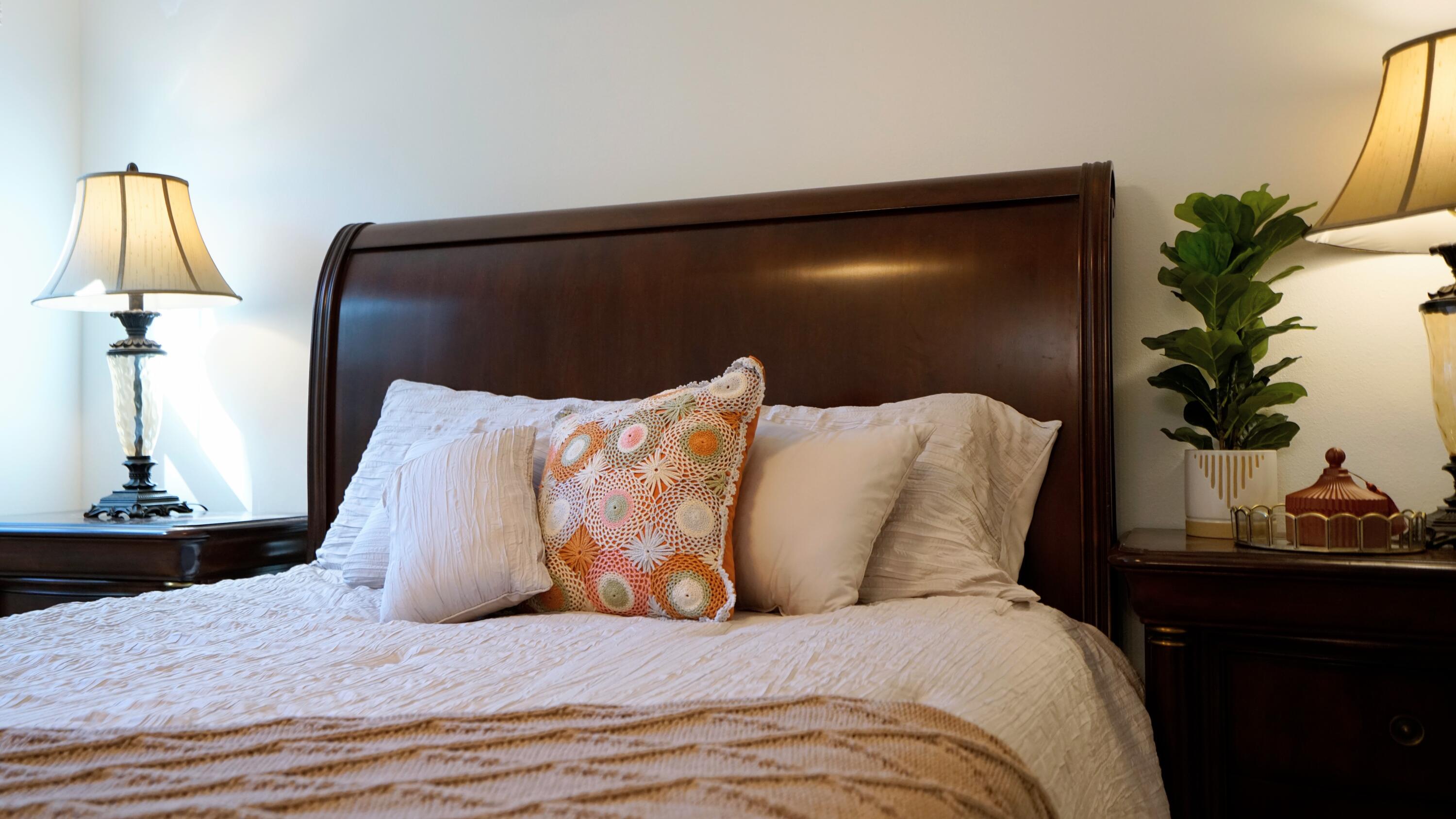 7667 North Wickham Road, Unit 1308 Melbourne, FL 32940 - Photo 17 of 56 a large bed sitting in a bedroom next to a window