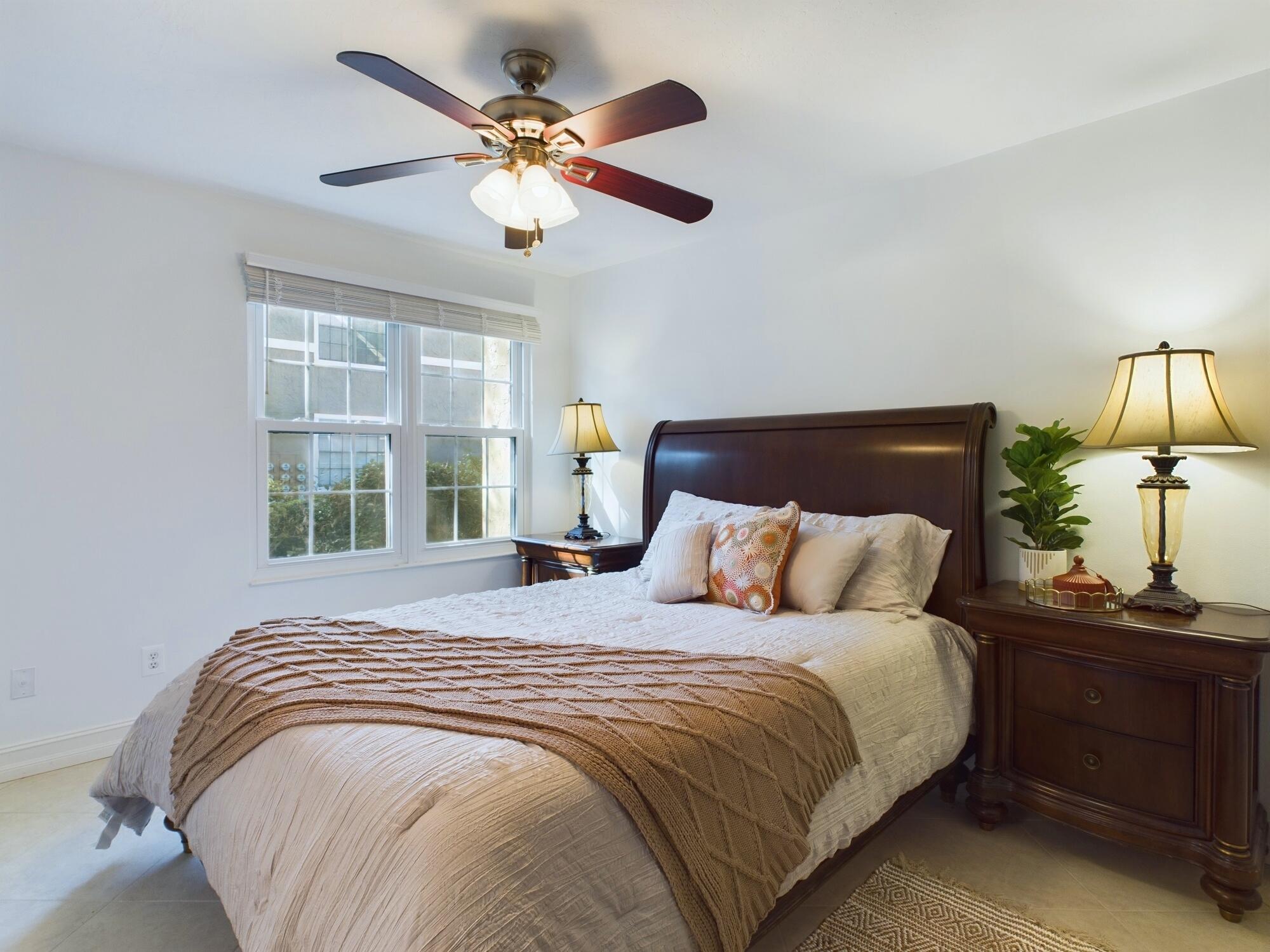7667 North Wickham Road, Unit 1308 Melbourne, FL 32940 - Photo 20 of 56 a bedroom with a large bed and a window