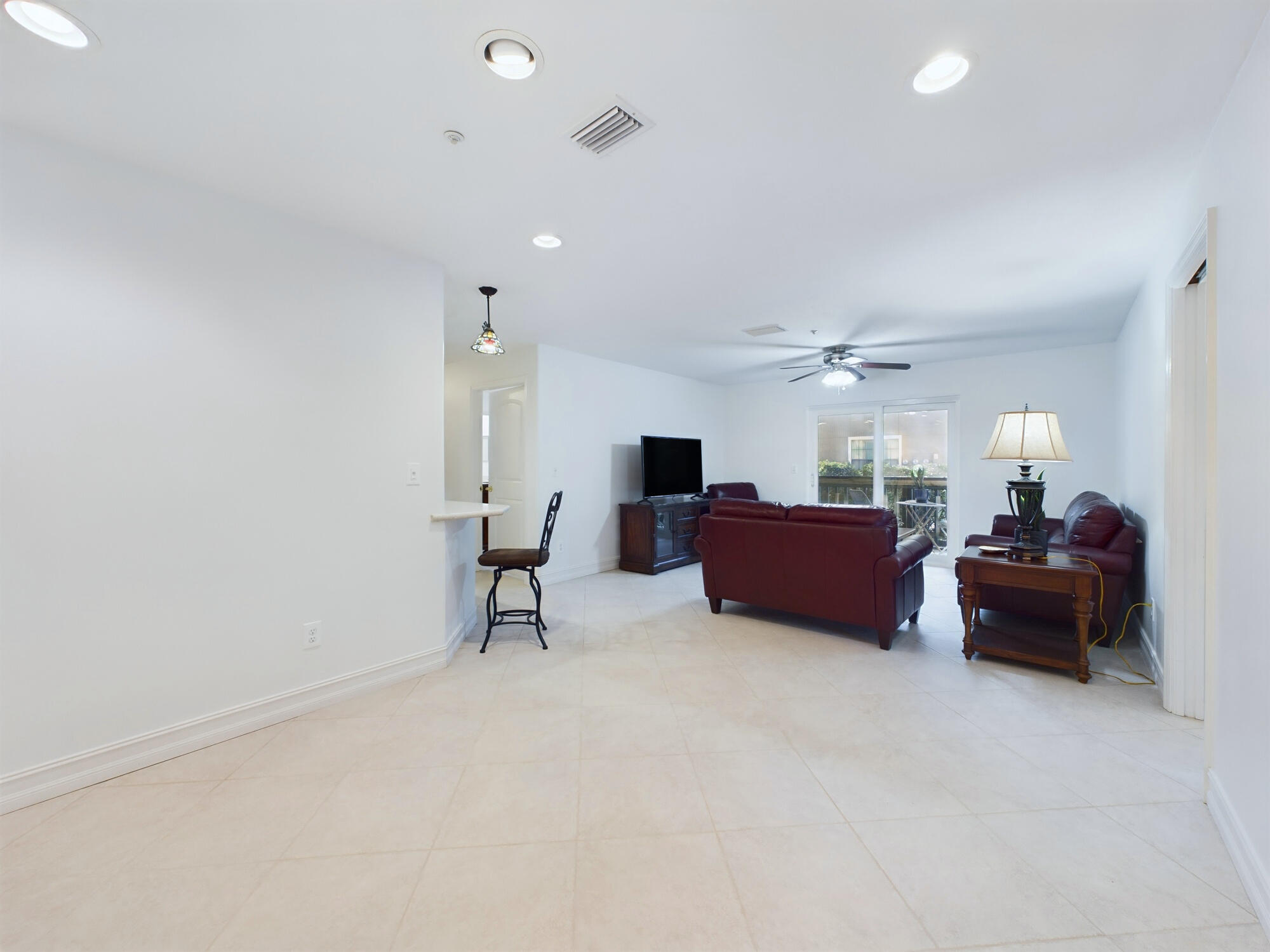 7667 North Wickham Road, Unit 1308 Melbourne, FL 32940 - Photo 23 of 56 a living room with furniture and a chandelier