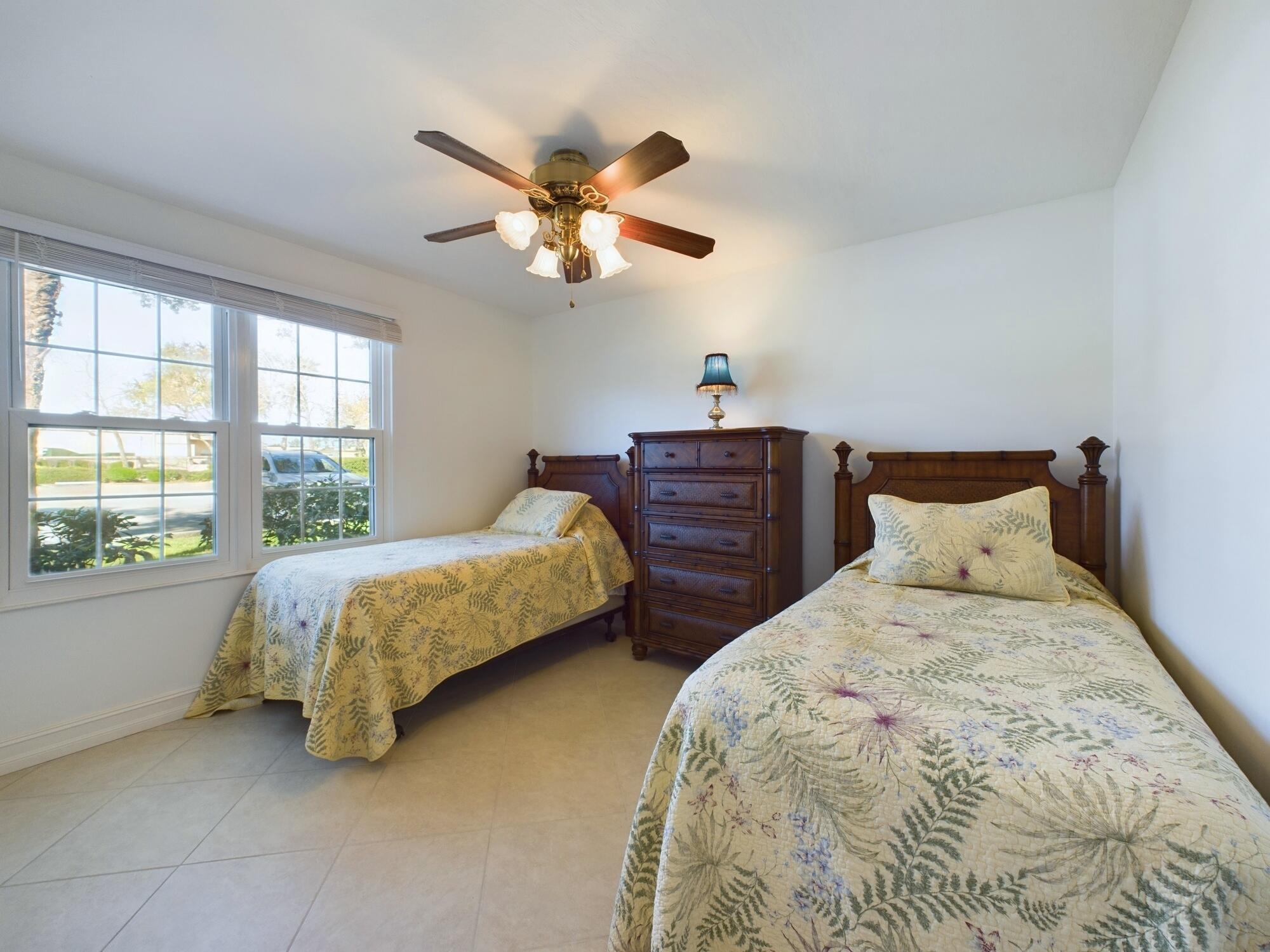 7667 North Wickham Road, Unit 1308 Melbourne, FL 32940 - Photo 35 of 56 a bedroom with two beds and a window