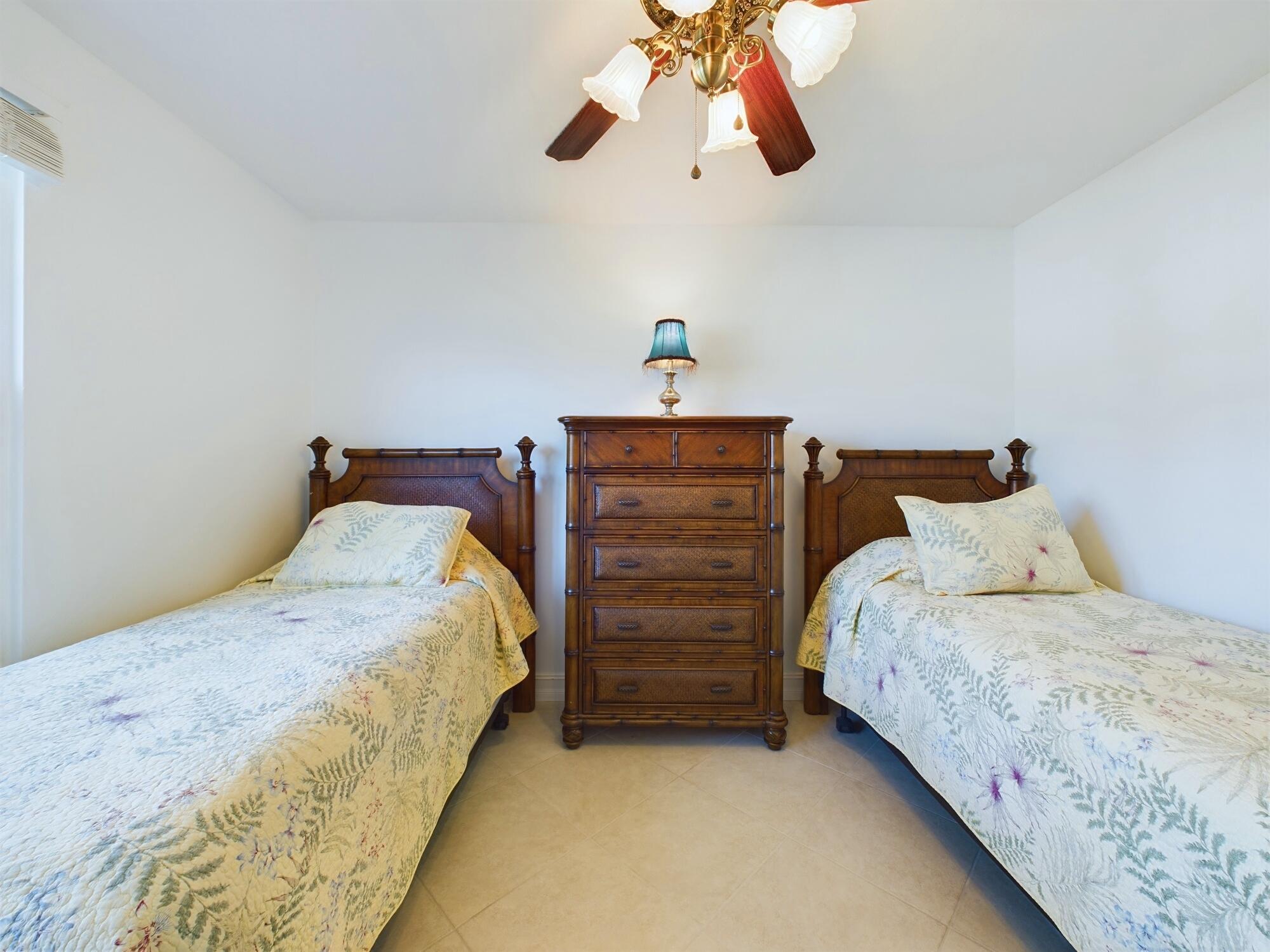 7667 North Wickham Road, Unit 1308 Melbourne, FL 32940 - Photo 37 of 56 a bedroom with a bed and cabinet