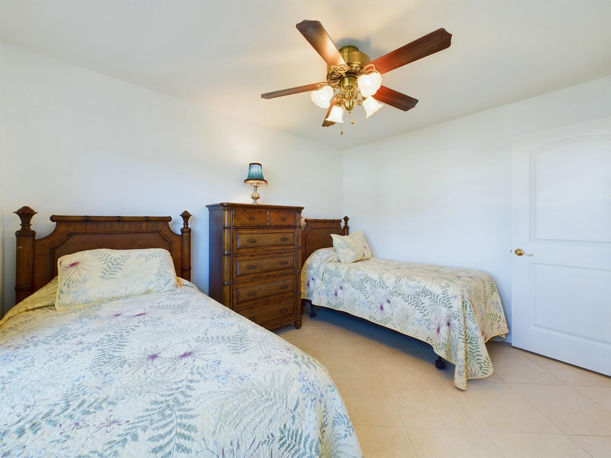7667 North Wickham Road, Unit 1308 Melbourne, FL 32940 - Photo 38 of 56 a bedroom with a bed and a chandelier