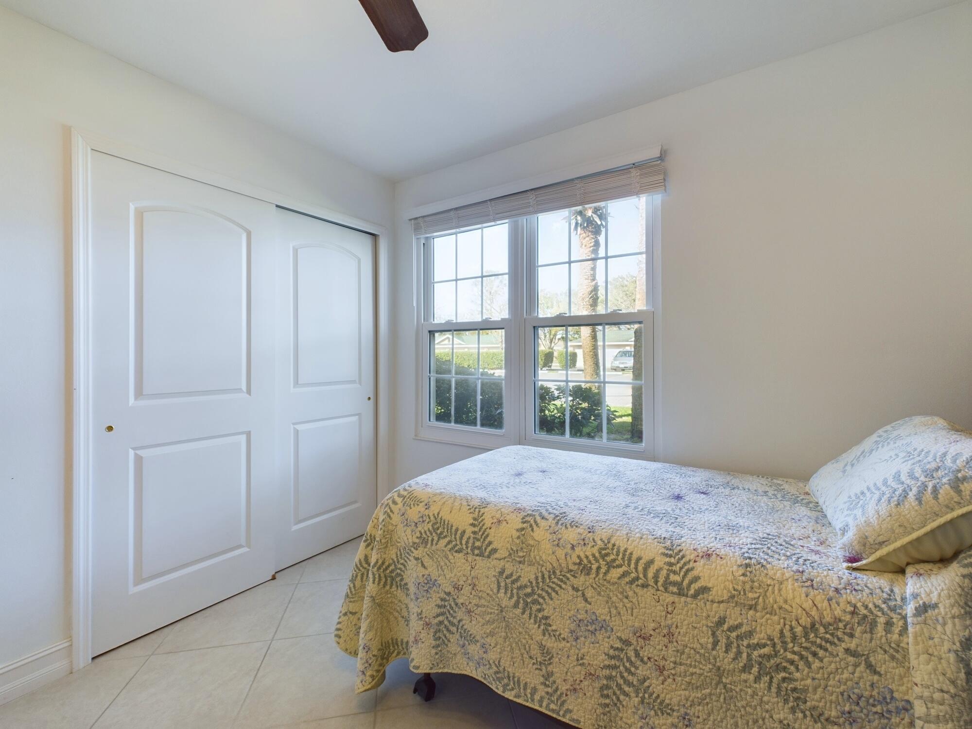 7667 North Wickham Road, Unit 1308 Melbourne, FL 32940 - Photo 39 of 56 a bedroom with a bed and a window