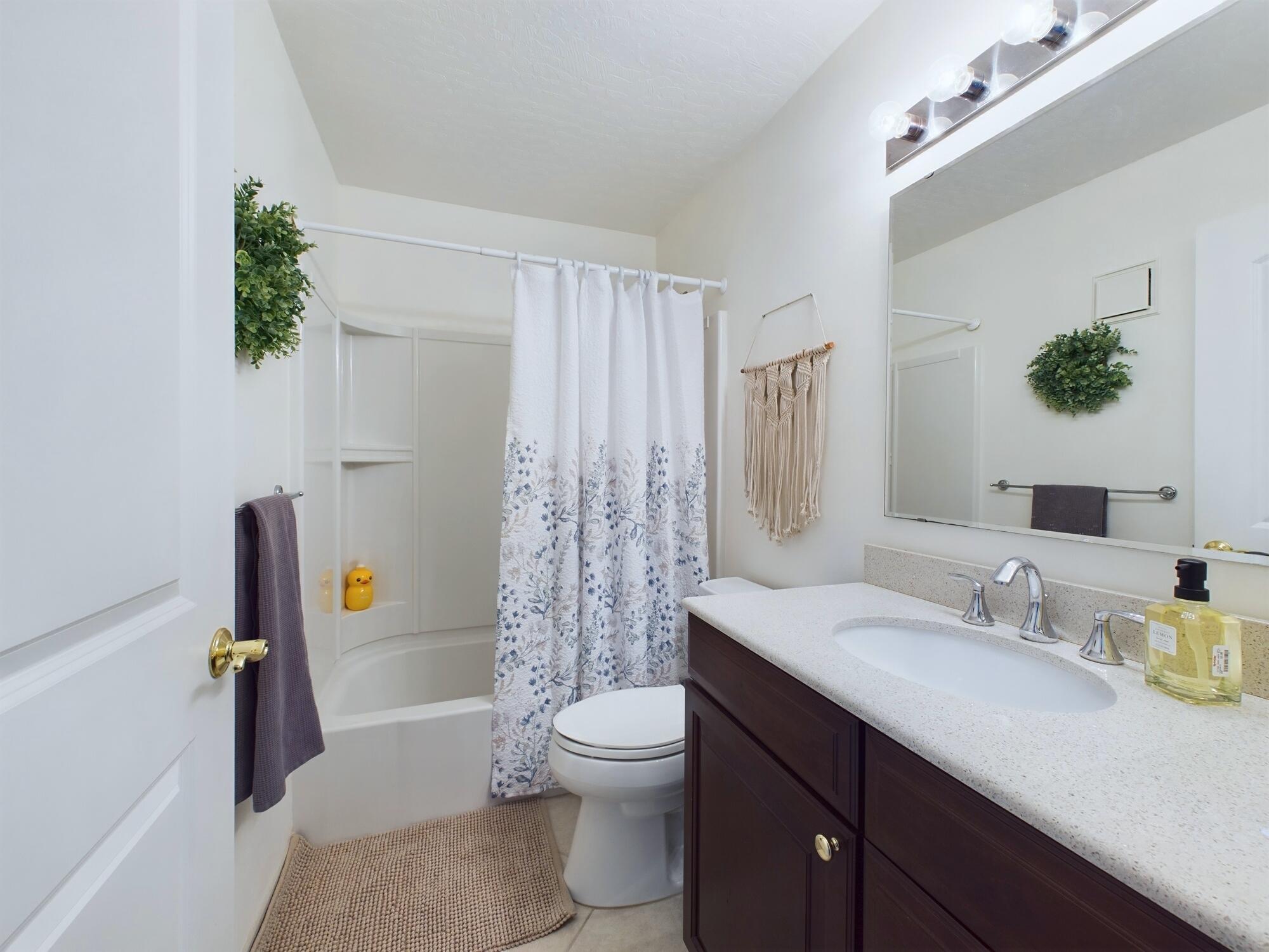 7667 North Wickham Road, Unit 1308 Melbourne, FL 32940 - Photo 40 of 56 a bathroom with a granite countertop sink a toilet and a tub