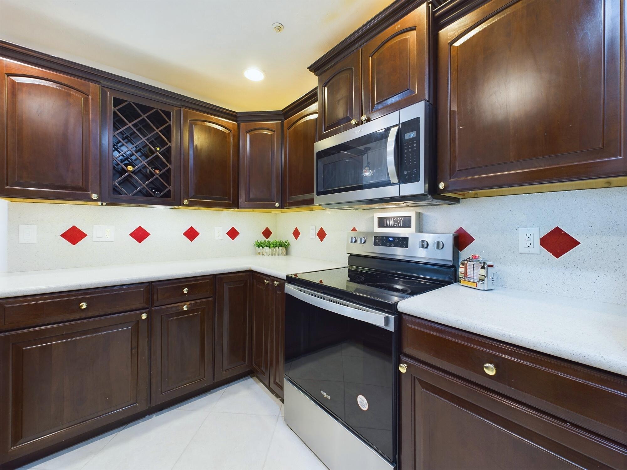 7667 North Wickham Road, Unit 1308 Melbourne, FL 32940 - Photo 4 of 56 a kitchen with stainless steel appliances granite countertop a sink and a microwave