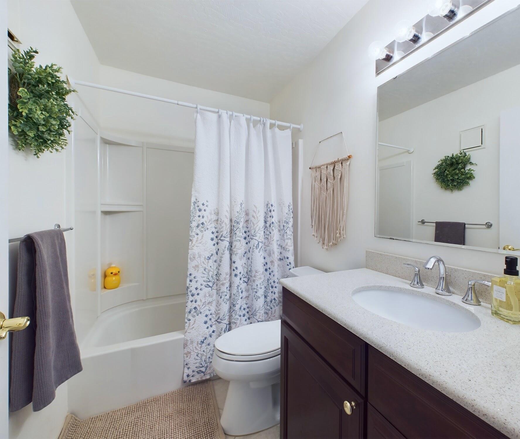 7667 North Wickham Road, Unit 1308 Melbourne, FL 32940 - Photo 41 of 56 a bathroom with a sink a toilet and shower