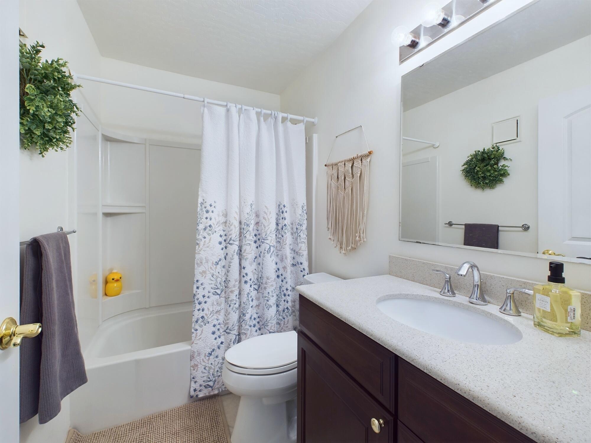 7667 North Wickham Road, Unit 1308 Melbourne, FL 32940 - Photo 42 of 56 a bathroom with a sink a toilet and shower