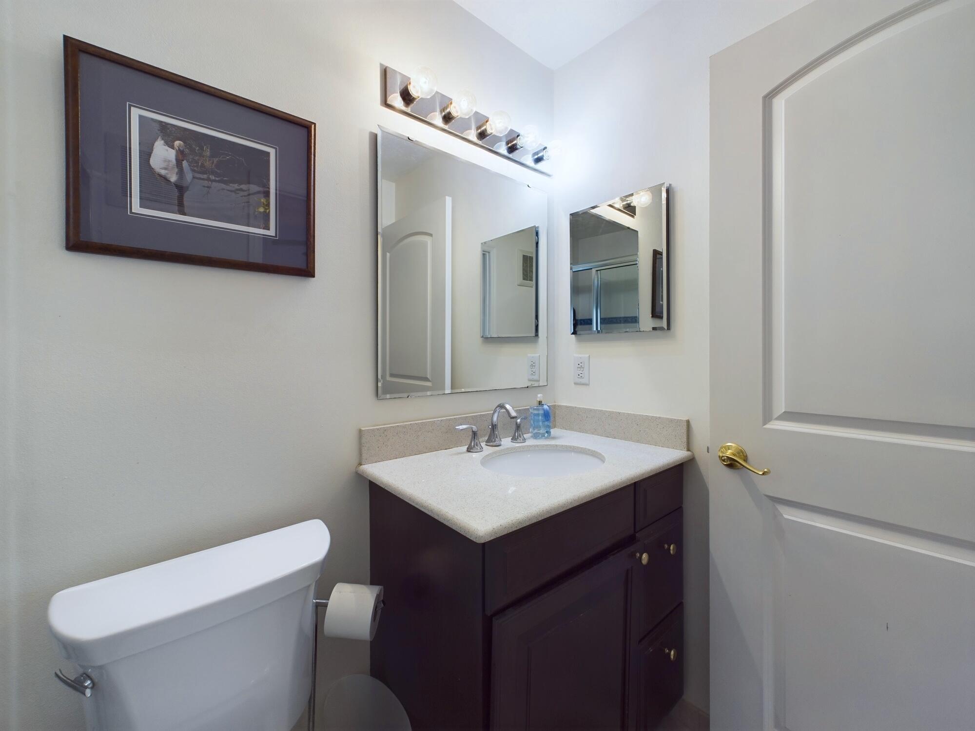 7667 North Wickham Road, Unit 1308 Melbourne, FL 32940 - Photo 43 of 56 a bathroom with a toilet a sink and mirror