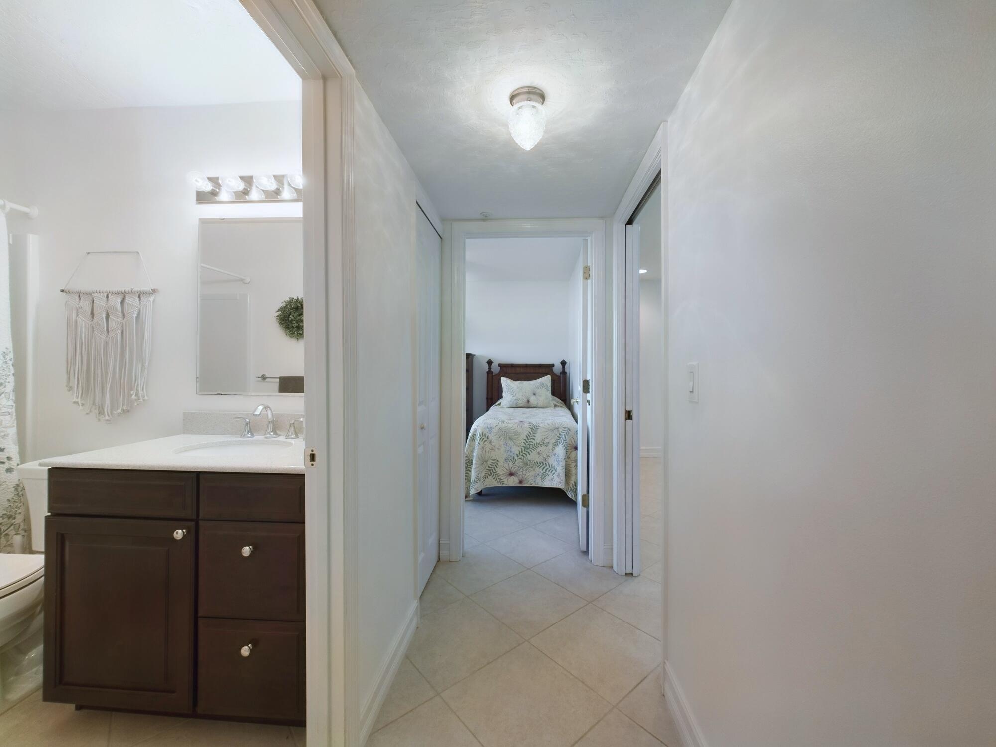 7667 North Wickham Road, Unit 1308 Melbourne, FL 32940 - Photo 44 of 56 a en suite bathroom with a sink and mirror