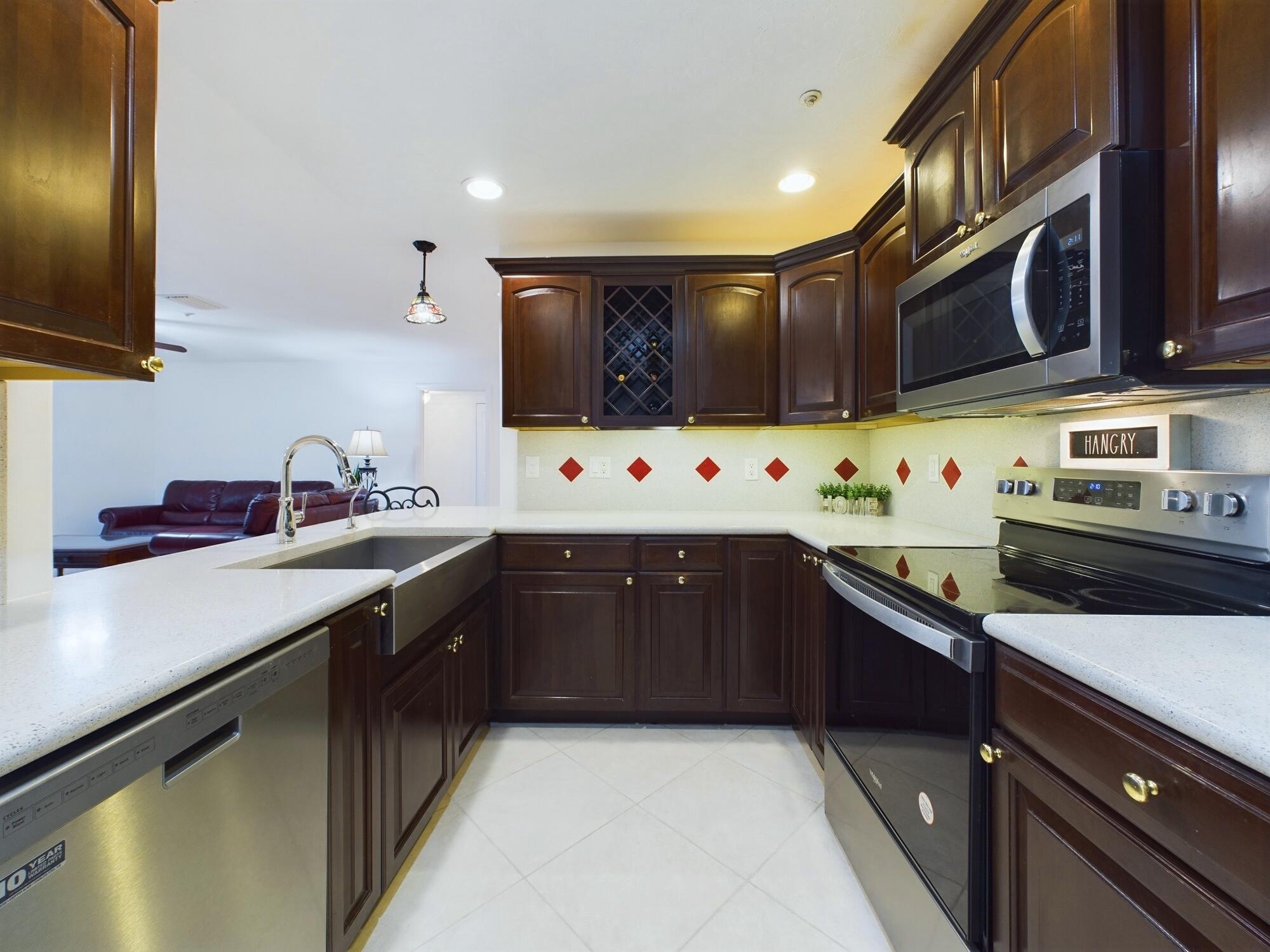 7667 North Wickham Road, Unit 1308 Melbourne, FL 32940 - Photo 5 of 56 a kitchen with stainless steel appliances a sink stove and cabinets