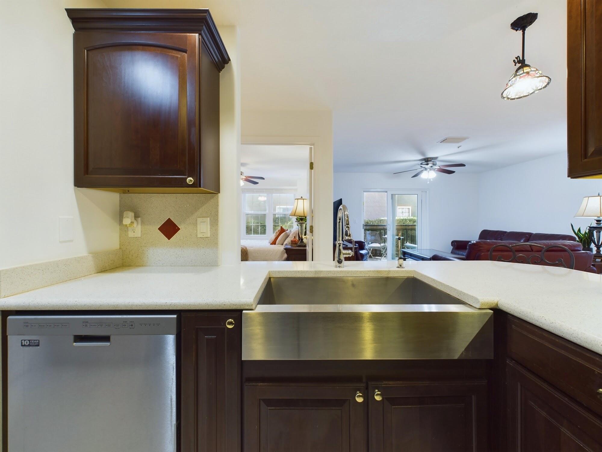 7667 North Wickham Road, Unit 1308 Melbourne, FL 32940 - Photo 6 of 56 a room with a sink and flat screen tv