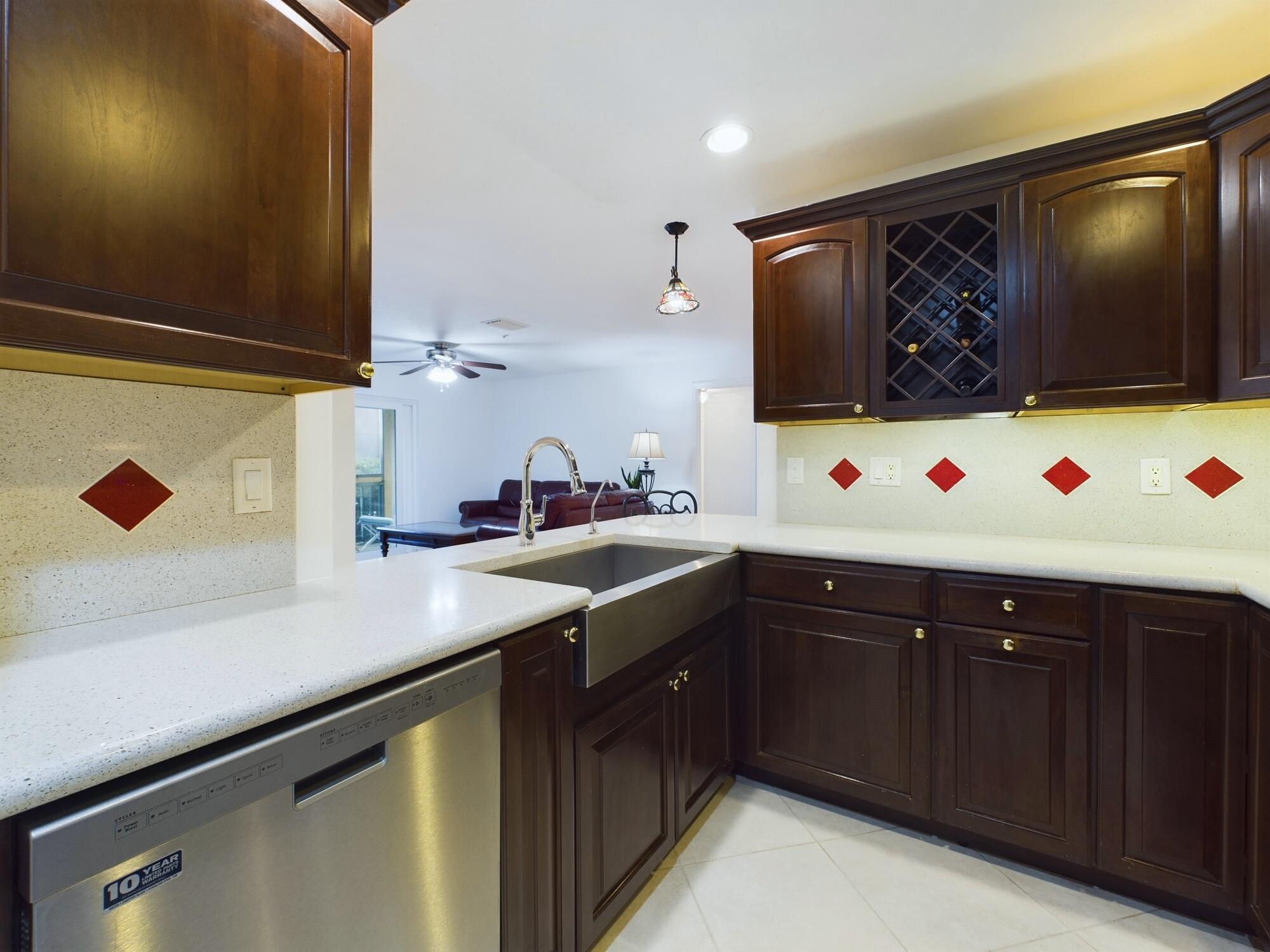 7667 North Wickham Road, Unit 1308 Melbourne, FL 32940 - Photo 8 of 56 a kitchen with stainless steel appliances a sink and a microwave