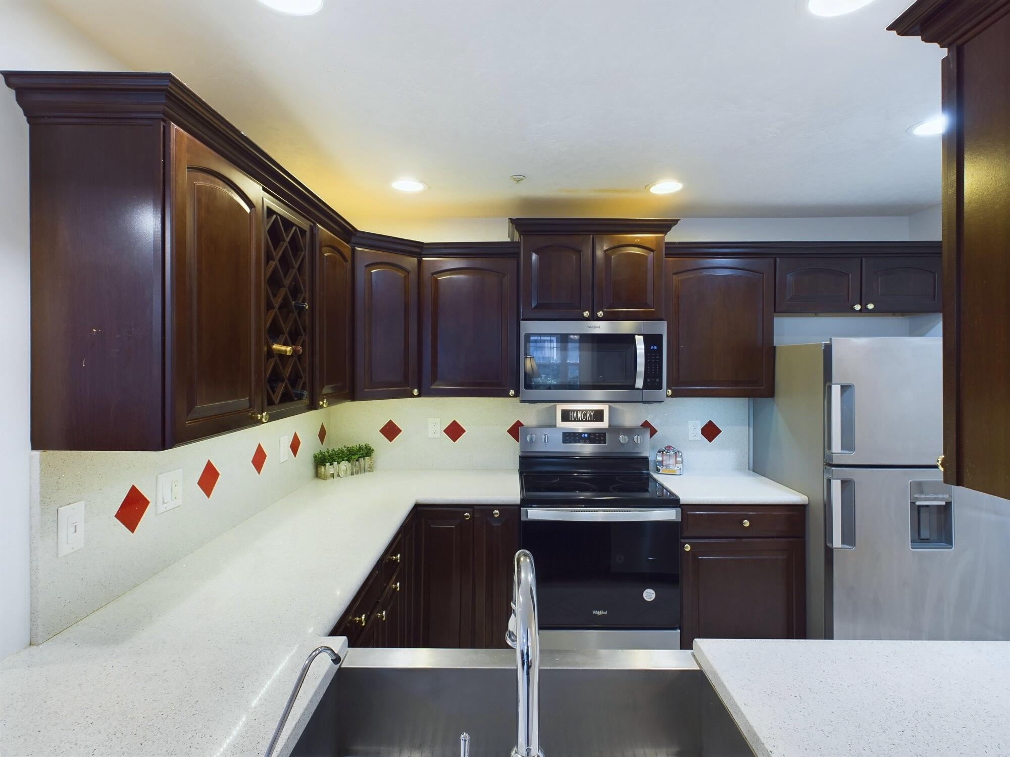 7667 North Wickham Road, Unit 1308 Melbourne, FL 32940 - Photo 9 of 56 a kitchen with stainless steel appliances a stove a refrigerator and a refrigerator