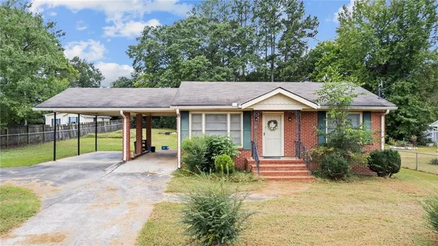 a view of house with a garden and pathway