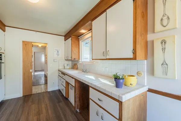 a kitchen with granite countertop a sink and a window
