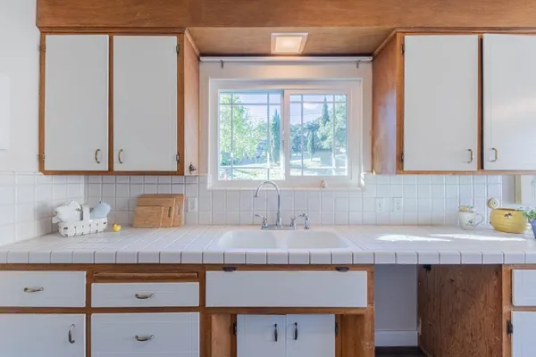 a kitchen with stainless steel appliances a stove and a microwave