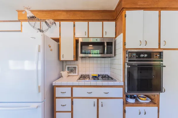 a kitchen with stainless steel appliances granite countertop a stove and a sink