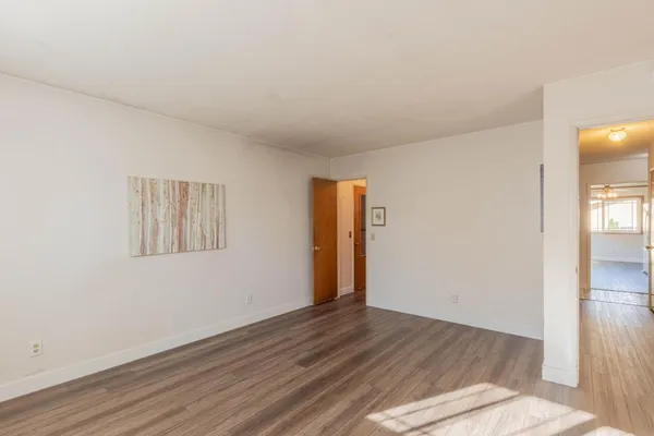 a view of a livingroom with wooden floor and closet