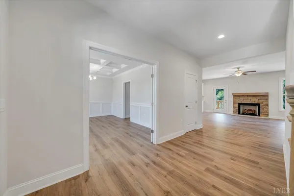 a view of empty room with wooden floor and fireplace