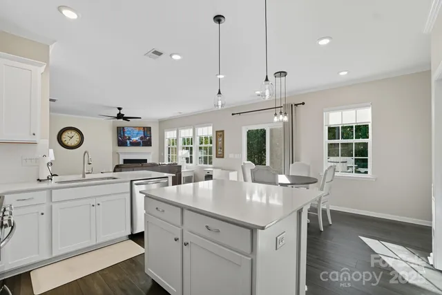 a kitchen with center island and sink