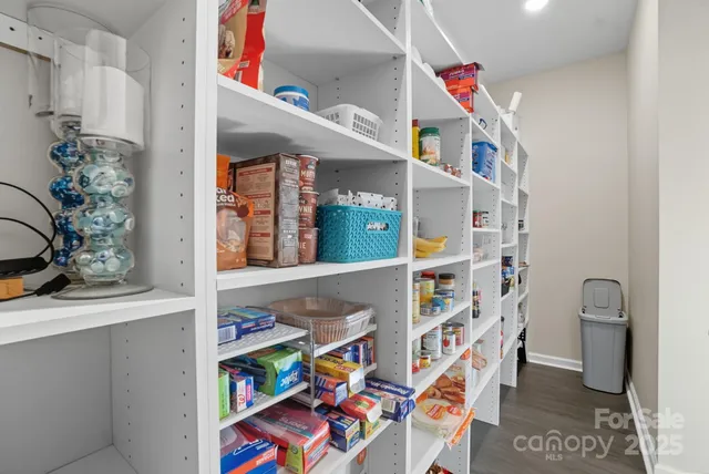 a living room with furniture and a book shelf