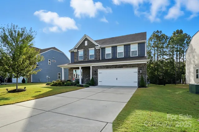 a front view of a house with a garden