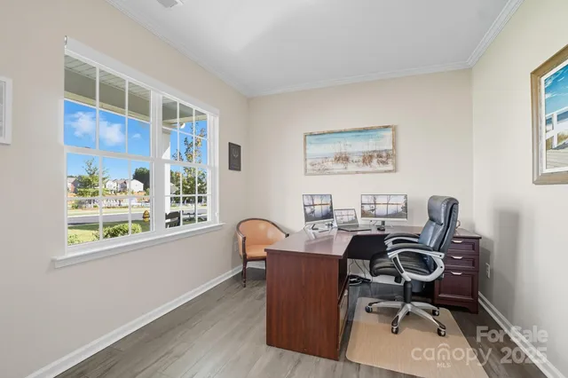 a view of a workspace with furniture and a window