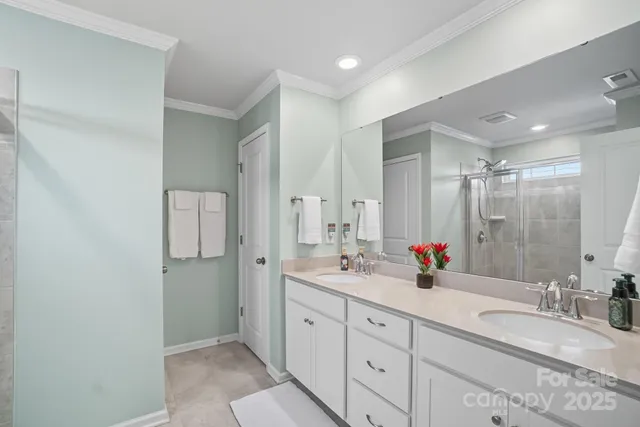 a bathroom with double sink and a mirror