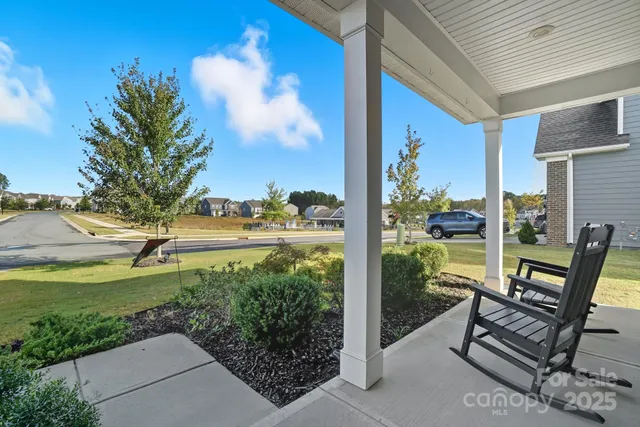 a view of a patio with table and chairs and potted plants