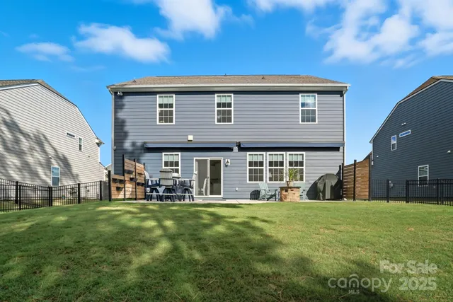 a front view of house with a garden