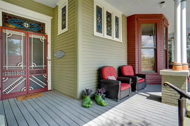 a view of a chairs and a table in the balcony