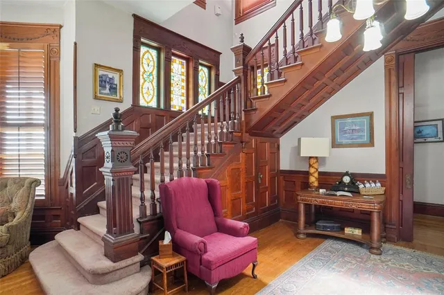 a living room with furniture fireplace and a window