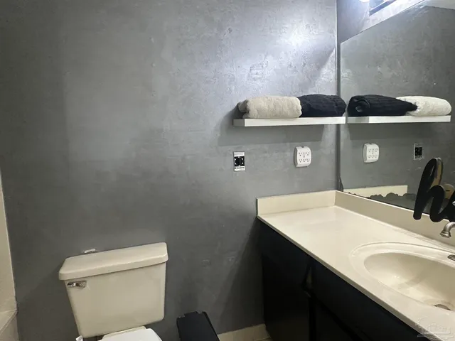 a bathroom with a sink toilet and vanity