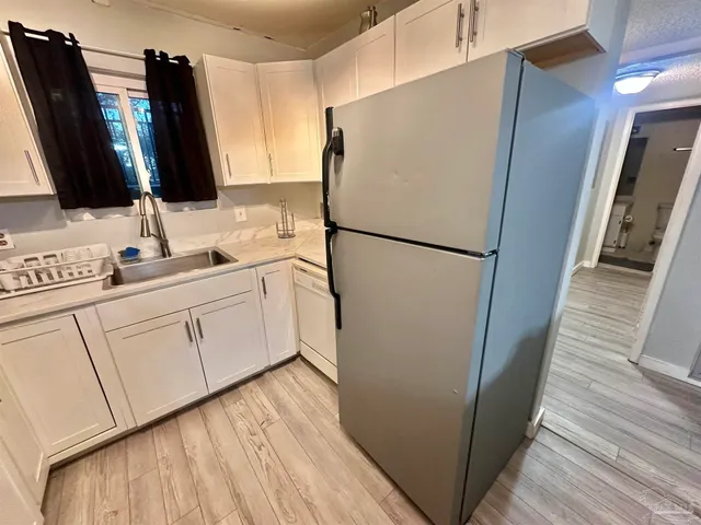 a white refrigerator freezer sitting inside of a kitchen